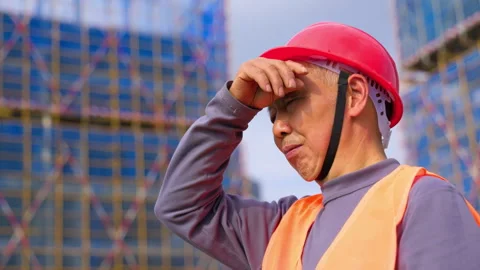 Confident construction man worker engineer wearing a red hard hat, orange Stock Footage 345862071