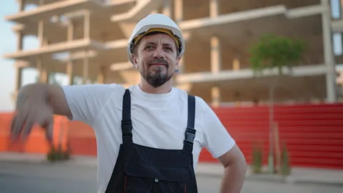 Confident construction worker wear white safety helmet and work overalls sm.. Stock Footage 341332187