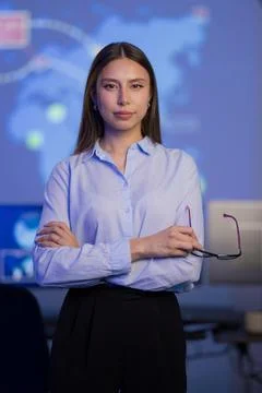 Confident cybersecurity analyst in a technology control room with advanced Stock-Fotos