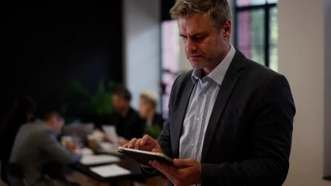 Confident data analytics new team member man browsing gadget. Businessman Stock Footage 256322689