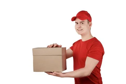 Confident delivery guy in a cap with a parcel in his hands, white background. Stock Photos