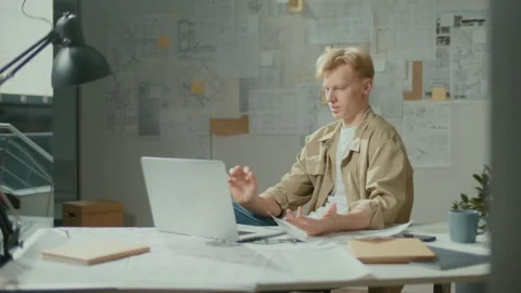 Confident Designer Architect Making Video Call and Working on Laptop at Office Stock Footage 239105702