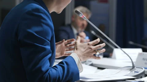 Confident director sitting at table at convention or seminar. Company briefing f Stock-Footage 199475377