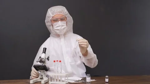 Confident doctor is testing a sample of biological tubes contaminated by Corona Stock Footage 146986620