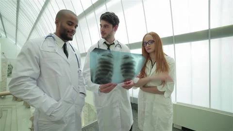 Confident doctors analyzing x-ray of healthy lungs in modern hospital Stock Footage 311661854