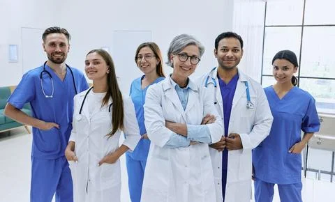 Confident doctors and nurses standing in modern hospital. Medical teamwork,.. Stock Photos