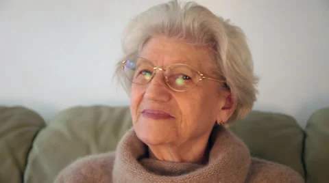 Confident eighty year old woman looking at the camera smiling and being happy Stock Footage 62775386