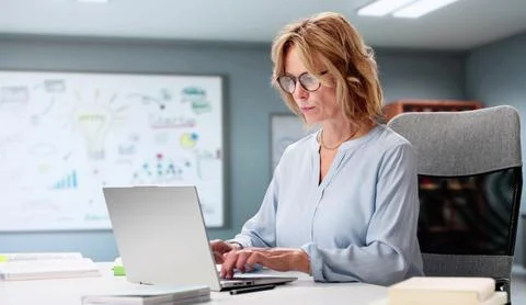 Confident Elderly Female Math Professor Helping Student With Laptop Tutoring Stock Photos