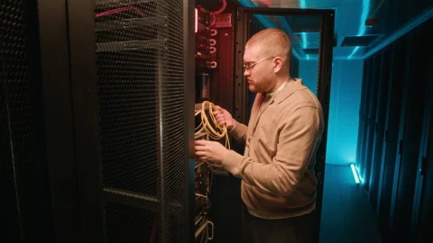 Confident Engineer Fixing Supercomputing System Using Cable in Server Room Stockbeeldmateriaal 311305448