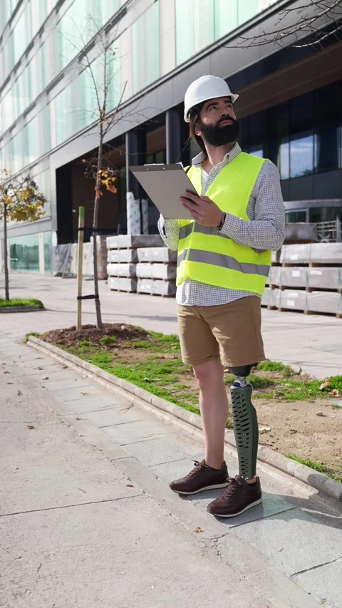 Confident Engineer with Prosthetic Leg Holding Clipboard on Site Stock Footage 264058910