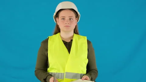Confident engineer in work vest and helmet holds clipboard Video stock 316106586