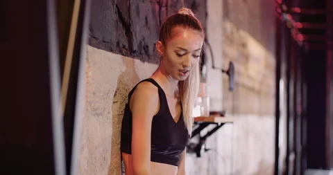 Confident Female Athlete Using Mobile Phone Stock-Footage 136676022