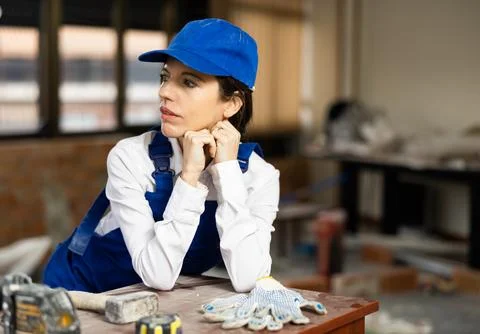 Confident female builder posing at construction site indoors Stock Photos