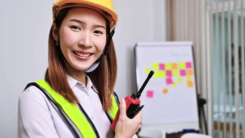Confident female building construction engineer wearing hardhat Stock Footage 154875674