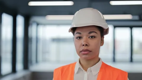 Confident Female Engineer in Hard Hat and Vest at Office Building Stock-Footage 308439645