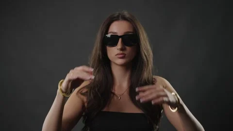 Confident female model posing in sunglasses, beauty and fashion concept, studio Stock Footage 336935895