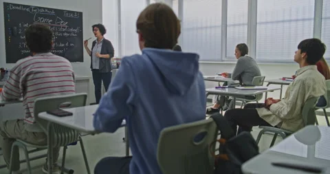 Confident Female Teacher Explains Coding Tasks to Students Stock Footage 321005634