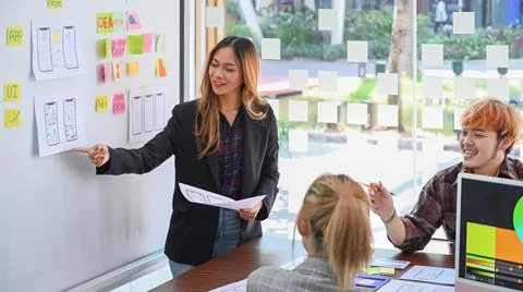 Confident female web developer is presenting sketch, prototype, framework Stockfoto's
