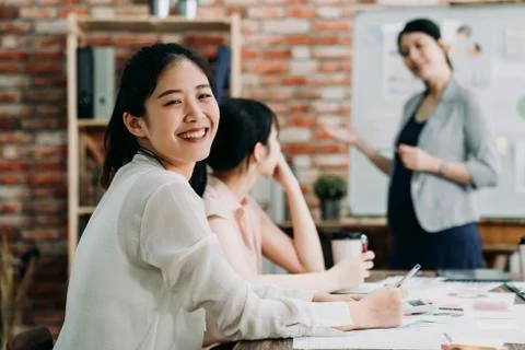 Confident female worker looking at camera smiling Stock Photos