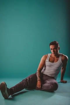 The Confident Fit Man Posing in Studio, Showing Muscles and Flexing Biceps on Stock Photos