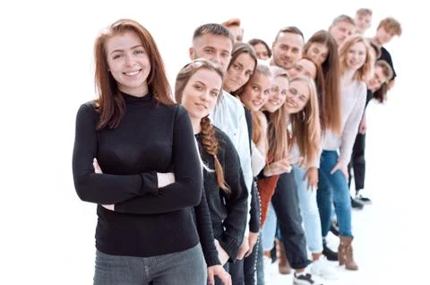 Confident guy standing first in the column of young people Stock Photos