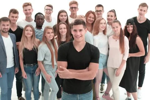 Confident guy standing in front of a group of young people Stock Photos
