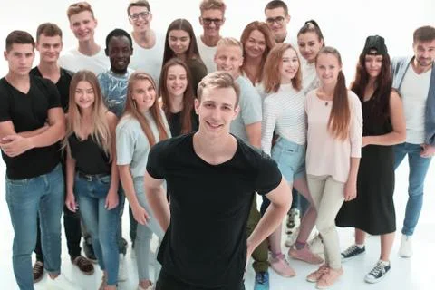 Confident guy standing in front of a group of young people Stock Photos