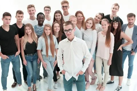 Confident guy standing in front of a group of young people Stock Photos