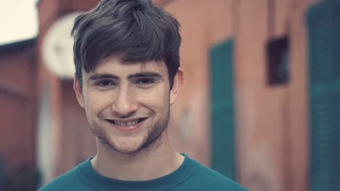 Confident Handsome young man looking at camera and smiling- close up-outdoor Stock Footage 115331332