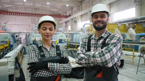 Confident industrial workers smiling at camera in factory Stock Footage 314582702