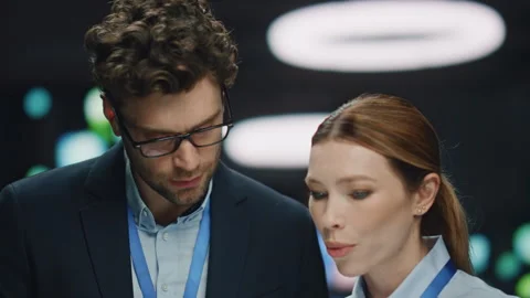 Confident IT admin talking colleague in data center closeup. Developers working Stock Footage 260252842