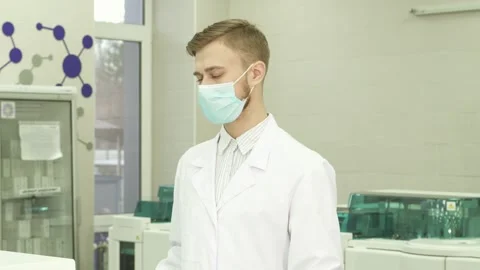 Confident lab assistant smiles while turning to the camera in a modern Stock-Footage 311952102