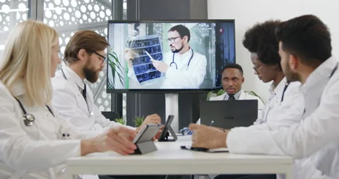 Confident likable concentrated wise multiethnic medical people holding online Stock Footage 142572515