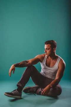 Confident Male Athlete Posing to Showcase Muscular Progress on Turquoise Stock Photos