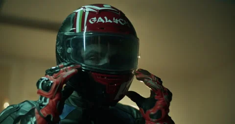 Confident male biker putting down visor of helmet Stock Footage 265008317
