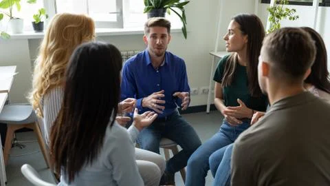 Confident male coach leader talking holding briefing for team employees. Stock Photos