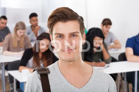 Confident Male Student Carrying Bag Stock Photos