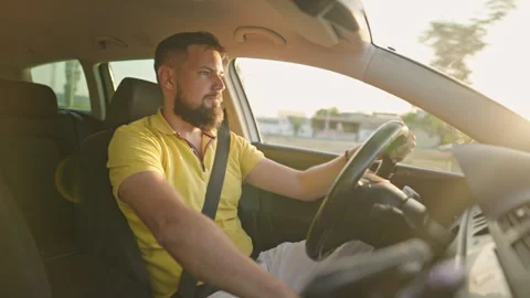 Confident Man Driving into Sunset Light on Scenic Road Stock Footage 311752715