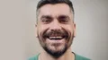 Confident man genuinely laughing at funny joke, close-up face with emotion HD Footage