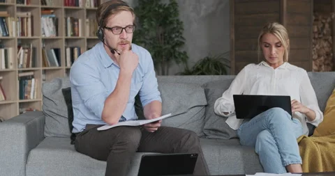 Confident man headset reading paper document studying online e learning at Stock Footage 165877104