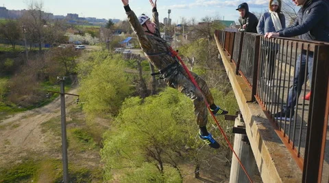 Confident man jumps down from the bridge Stock Footage 68350289