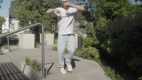 Confident man performing dynamic freestyle dance with kicks and fluid movements. Stock Footage 283990239