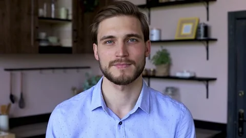 Confident man pretty face looking at camera posing alone at home in office. Stock Footage 131954075