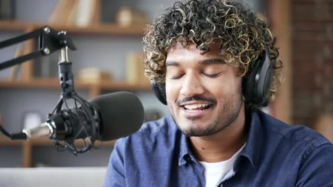 Confident man recording podcast using laptop and microphone in home office. Male 스톡 동영상 334228301
