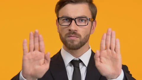 Confident man showing stop gesture, refusal of bribes, honest business, close-up Stock Footage 104701501