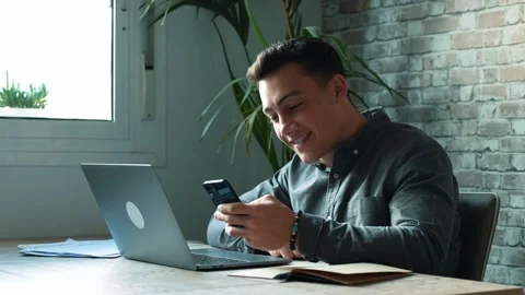 Confident man sitting at desk taking break in work with electronic document.. Stock Footage 236929976