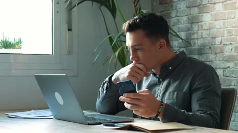 Confident man sitting at desk taking break in work with electronic document.. Stock Footage 236932263
