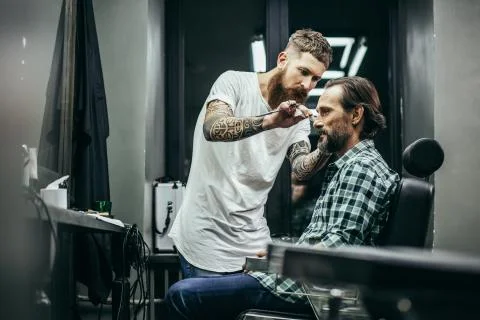 Confident man smiling while his barber working Foto stock