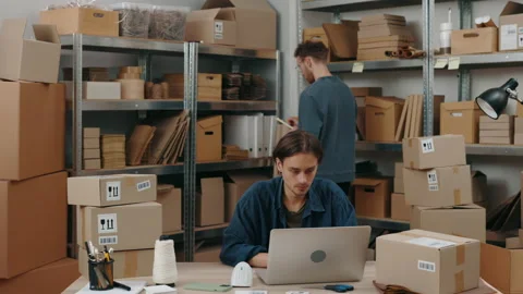 Confident man standing with folder at his hands and looking at the shelves while Stock Footage 195245246