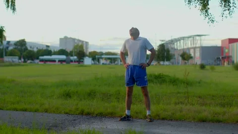 A confident man stands on a scenic path, embodying empowerment Stock Footage 317339212